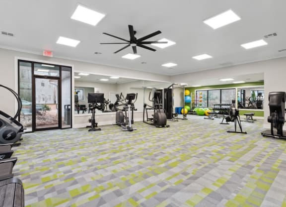 Community Fitness Center with Equipment and Mirrors at Element 41 Apartments in Marietta, GA.