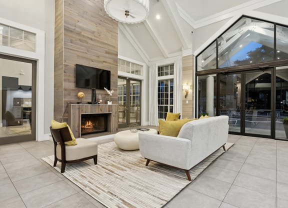 Community Clubhouse with Lounge Furniture and Fireplace at Caribbean Breeze Apartments in Tampa, FL.