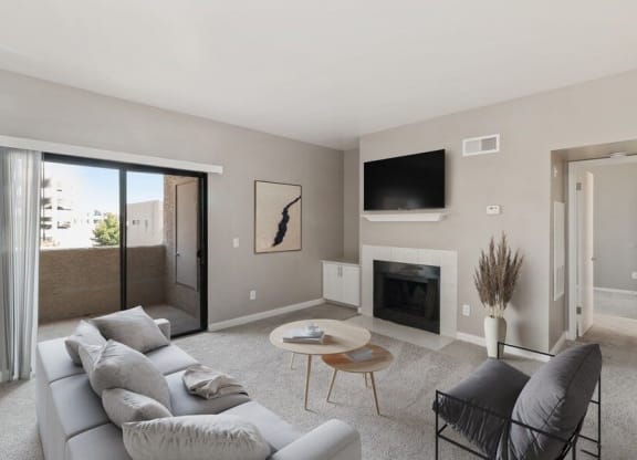 Model living room with fireplace and private patio