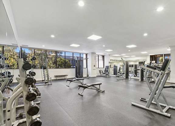 Community Fitness Center with Equipment at Madison Park Apartments located in Anaheim, CA.