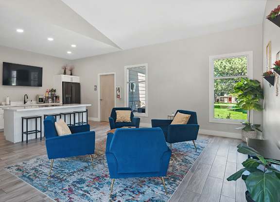 Community Clubhouse with Lounge Furniture and Kitchenette Area at Broadmoor Village Apartments located in West Jordan, UT.