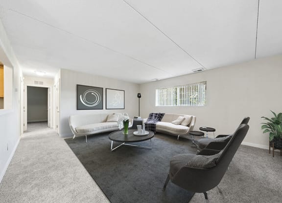 Model Living Room with Carpet and Hallway View at Heights Marlborough Apartments in Boston, MA.