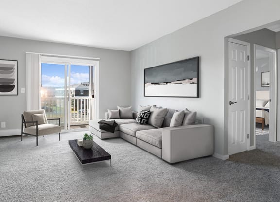 Model Living Room with Carpet and Patio Accessibility at Stone Ends Apartments in Stoughton, MA.
