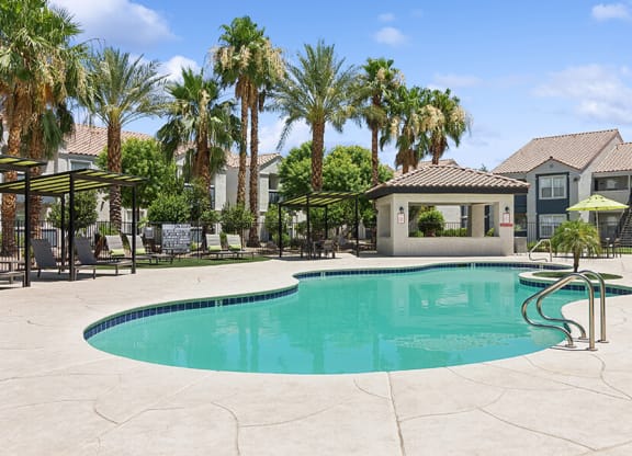 Community Swimming Pool with Pool Furniture at Monterra Apartments located in Las Vegas, NV.