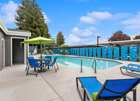 Community Swimming Pool with Pool Furniture at Meritage Apartments in Vallejo, CA.