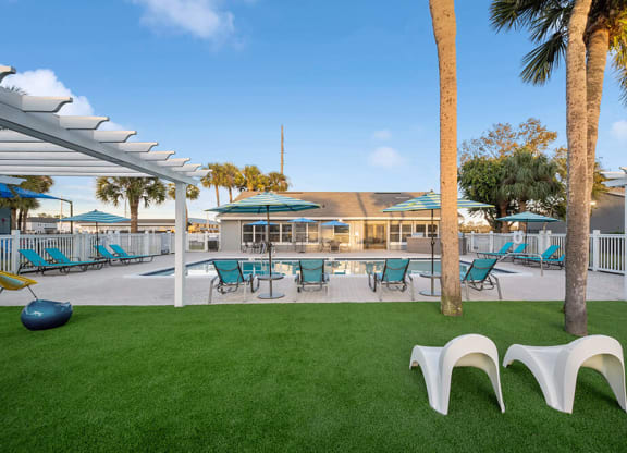 Community Swimming Pool with Pool Furniture at Park at 7200 Apartments in Jacksonville, FL.