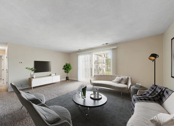 Model Living Room with Carpet and Patio Accessibility at Meadows at Marlborough Apartments in Boston, MA.