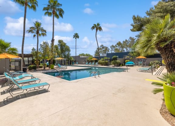 Community Swimming Pool with Pool Furniture at Lakeside Casitas Apartments in Tucson, AZ.