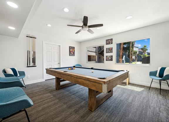Community Clubhouse with Game Tables and Lounge Furniture at Country Club Verandas Apartments located in Mesa, AZ.