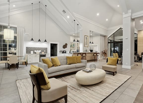 Community Clubhouse with Lounge Furniture and Kitchenette Area at Caribbean Breeze Apartments in Tampa, FL.