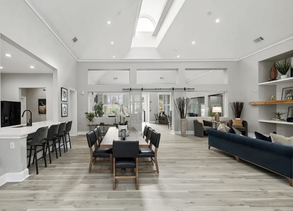 Community Clubhouse with Lounge Furniture and Kitchenette Area at Bridges at Oakbend Apartments in Lewisville, TX.