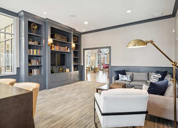 Community Clubhouse with Lounge Furniture and TV at Dulles Green Apartments located in Herndon, VA.