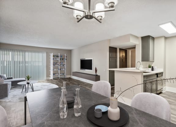 Model dining area with view of living room and kitchen
