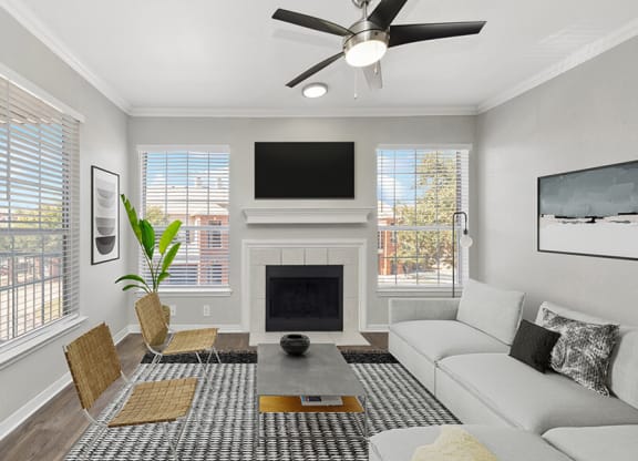 Model Living Room with Wood-Style Flooring and Fireplace at Chapel Hill Apartments in Lewisville, TX.