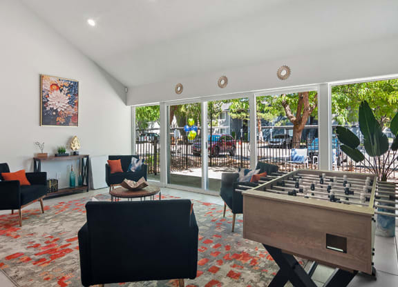 Community Clubhouse with Lounge Furniture and Game Tables at Overlook Apartments located in Salt Lake City, UT.