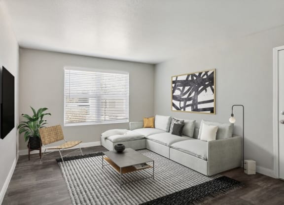 Model living room with a couch and a coffee table