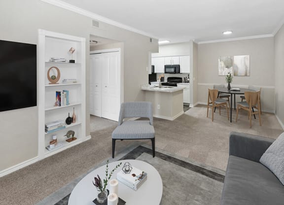 Model Living Room and Dining Room Area with Carpet at Belmont at Duck Creek Apartments in Garland, TX.