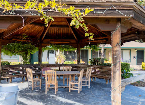 Covered patio with picnic tables at The Grove at Walnut Creek Apartments in Walnut Creek, CA.