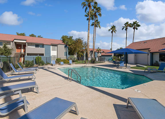 Community Swimming Pool with Pool Furniture at Peaks on 4th Apartments in Avondale, AZ.