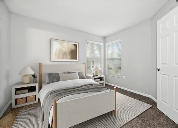Model Bedroom with Carpet and Window View at Retreat at Crosstown Apartments in Riverview, FL.