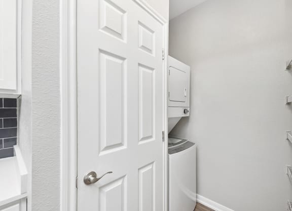 Model Laundry Room with Washer & Dryer at Hidden Creek Apartments located in Lewisville, TX.