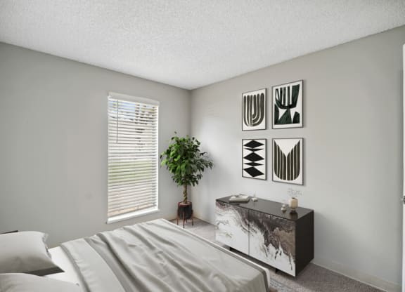 a bedroom with a bed and a dresser in front of a window