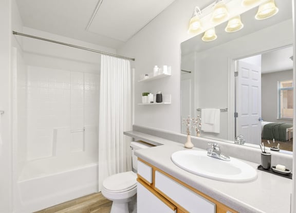 Model Bathroom with Wood-Style Flooring and Shower/Tub at Altitude on Fifth Apartments in Salt Lake City, UT.