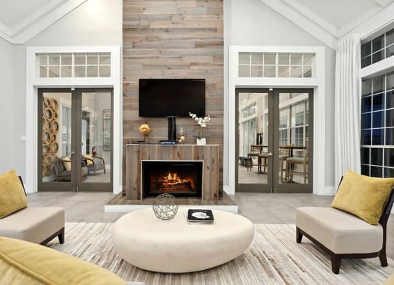 Community Clubhouse with Lounge Furniture and Fireplace at Caribbean Breeze Apartments in Tampa, FL.