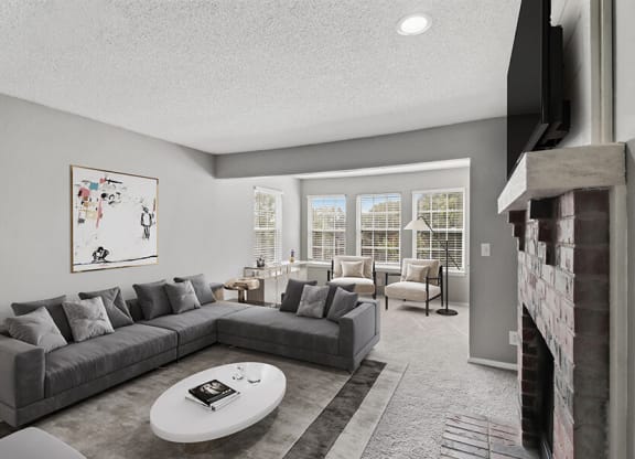 Model Living Room with Carpet and Fireplace at Abbington Heights Apartments in Antioch, TN.