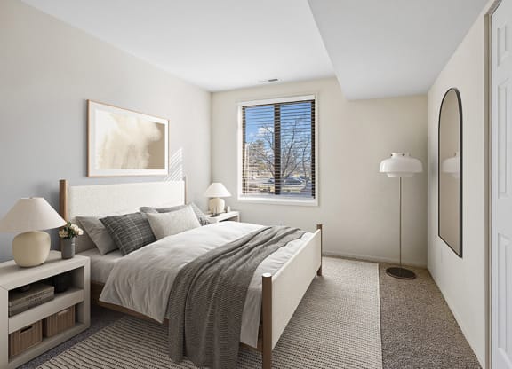 Model Bedroom with Carpet and Window View at Spring Parc Apartments in Silver Spring, MD.