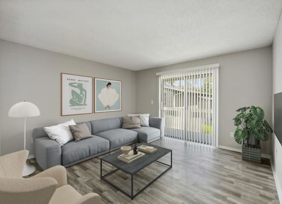 Model living room with couch and sliding glass door