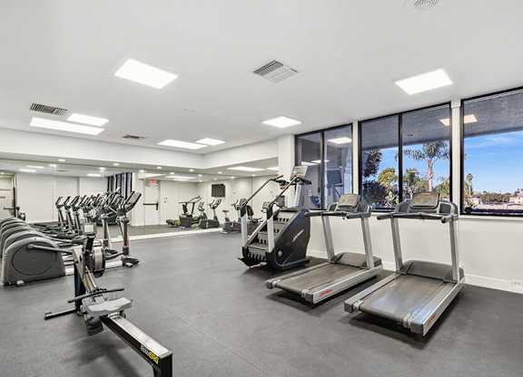 Community Fitness Center with Equipment at Madison Park Apartments located in Anaheim, CA.