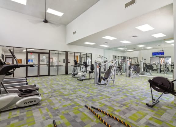 a gym with treadmills and other exercise equipment
