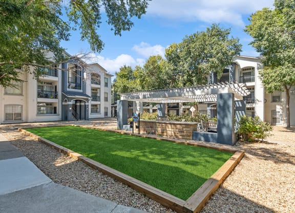 Outdoor Grass Area & Covered Patio BBQ Area at Allure North Dallas Apartments in Dallas, TX.