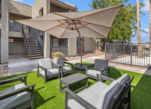 Outdoor Lounge Area with Covered Furniture at Saddle Ridge Apartments in Tucson, AZ.