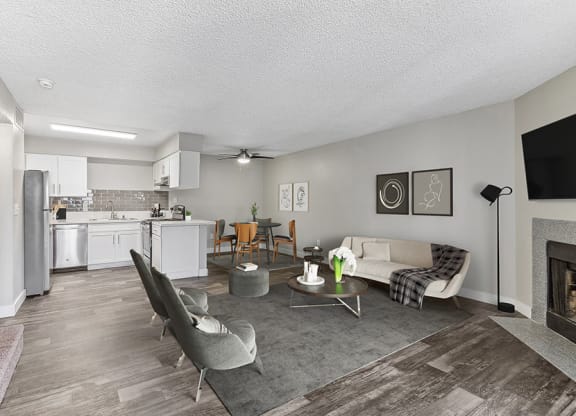 Model Living Room with Wood-Style Flooring and Fireplace at Meadow Ridge Apartments in Las Vegas, NV.