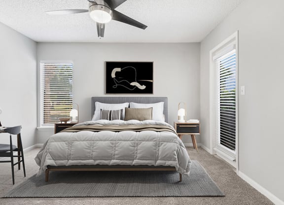 Model Bedroom with Carpet and Patio Accessibility at Rosehill Preserve Apartments located in Orlando, FL.