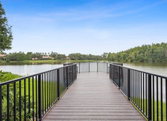 Long wooden dock over pond with look out point
