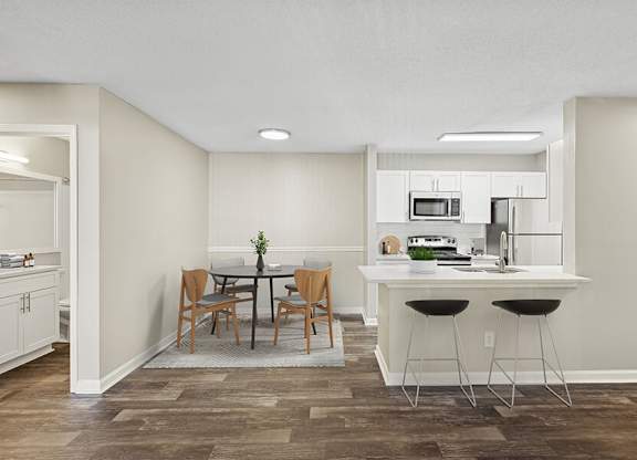 Model Dining Room and Kitchen Area with Wood-Style Flooring at Element 41 Apartments located in Marietta, GA.