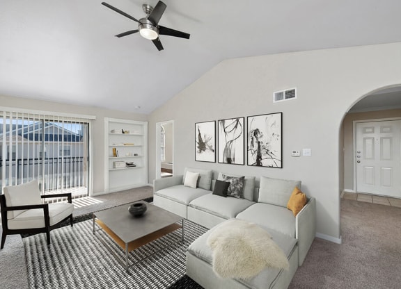 Model Living Room with Carpet and Patio Accessibility at Hidden Creek Apartments in Lewisville, TX.