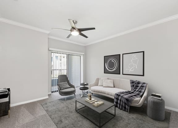 Model Living Room with Carpet and Patio Accessibility at Hidden Creek Apartments located in Lewisville, TX.