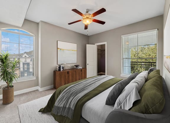 Model Bedroom with Carpet and Window Views at Park West Apartments located in Houston, TX.
