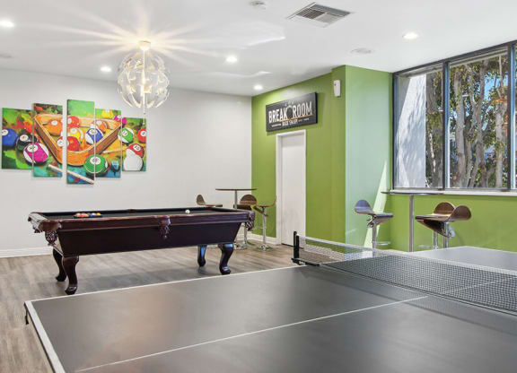 Community Clubhouse with Game Tables and Lounge Furniture at Madison Park Apartments located in Anaheim, CA.