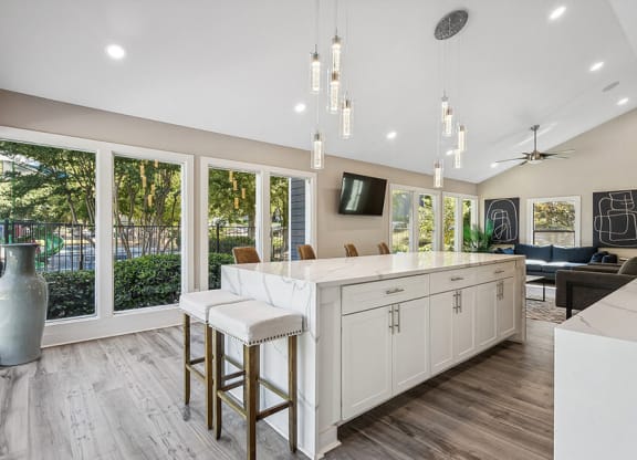 Community Clubhouse with Kitchenette and Lounge Furniture at Lakeside Retreat Apartments located in Peachtree Corners, GA.