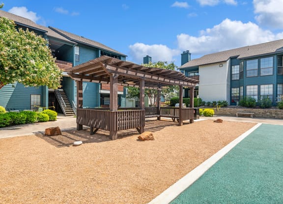 Outdoor Covered Seating Area at Bridges at Deer Run Apartments in Dallas, TX.