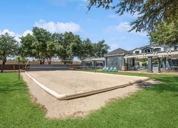 Outdoor Sand Volleyball Court with Net at Allure North Dallas Apartments in Dallas, TX.