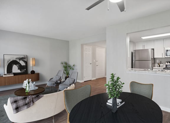 Model Living/Dining Room with Wood-Style Flooring and View of Kitchen at Overlook Point Apartments in Salt Lake City, UT.