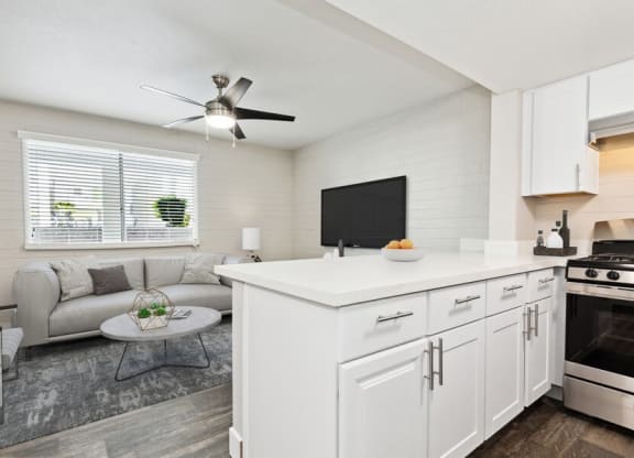 Model kitchen with bar seating and living room