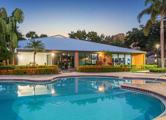 Community Swimming Pool with Pool Furniture at Bridges at Bayside Apartments in St. Petersburg, FL.