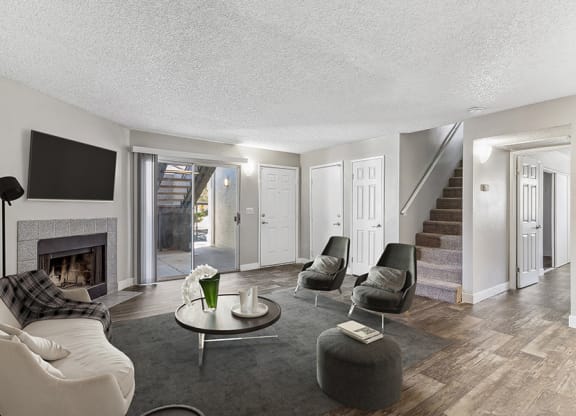 Model Living Room with Wood-Style Flooring and Patio Accessibility at Meadow Ridge Apartments in Las Vegas, NV.